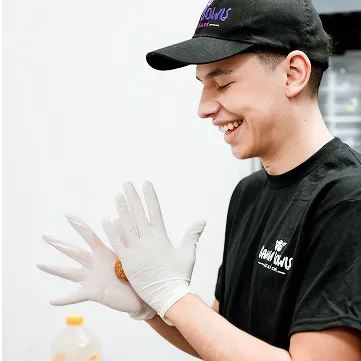 smiling employee with white gloves on